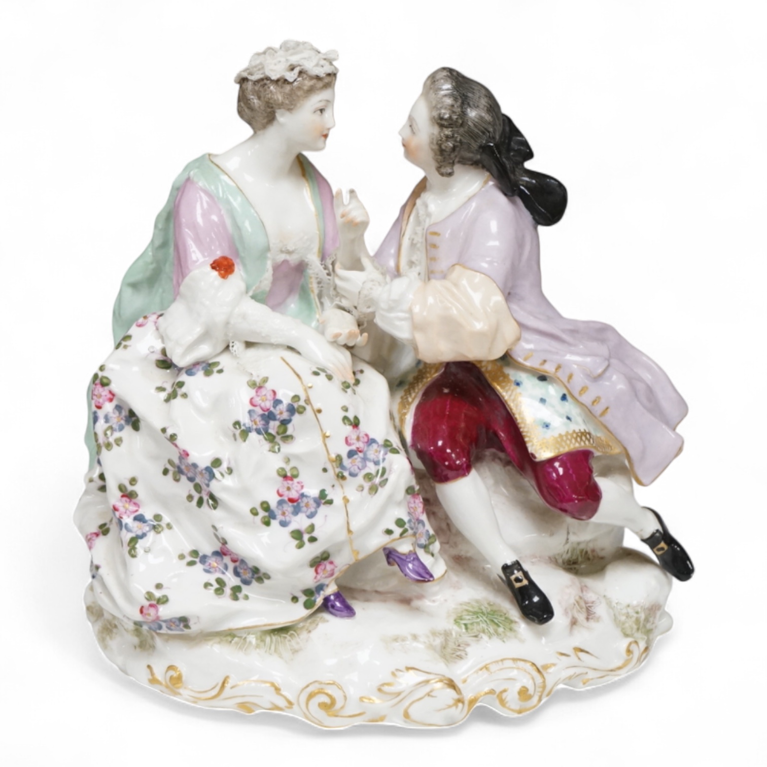 A German porcelain group of a seated courting couple, 16.5cm high
